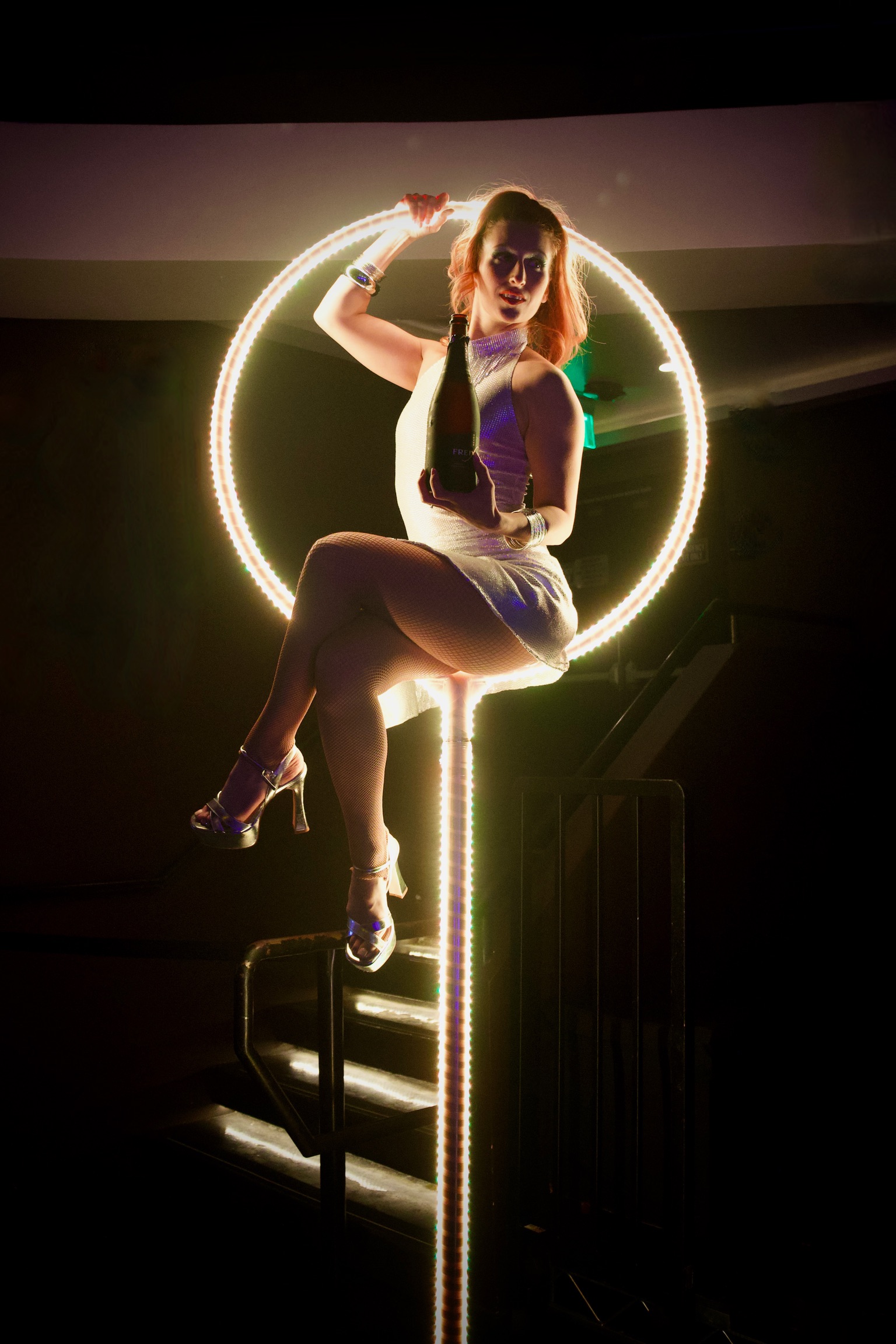 Circensia performer in an illuminated hoop at a private event