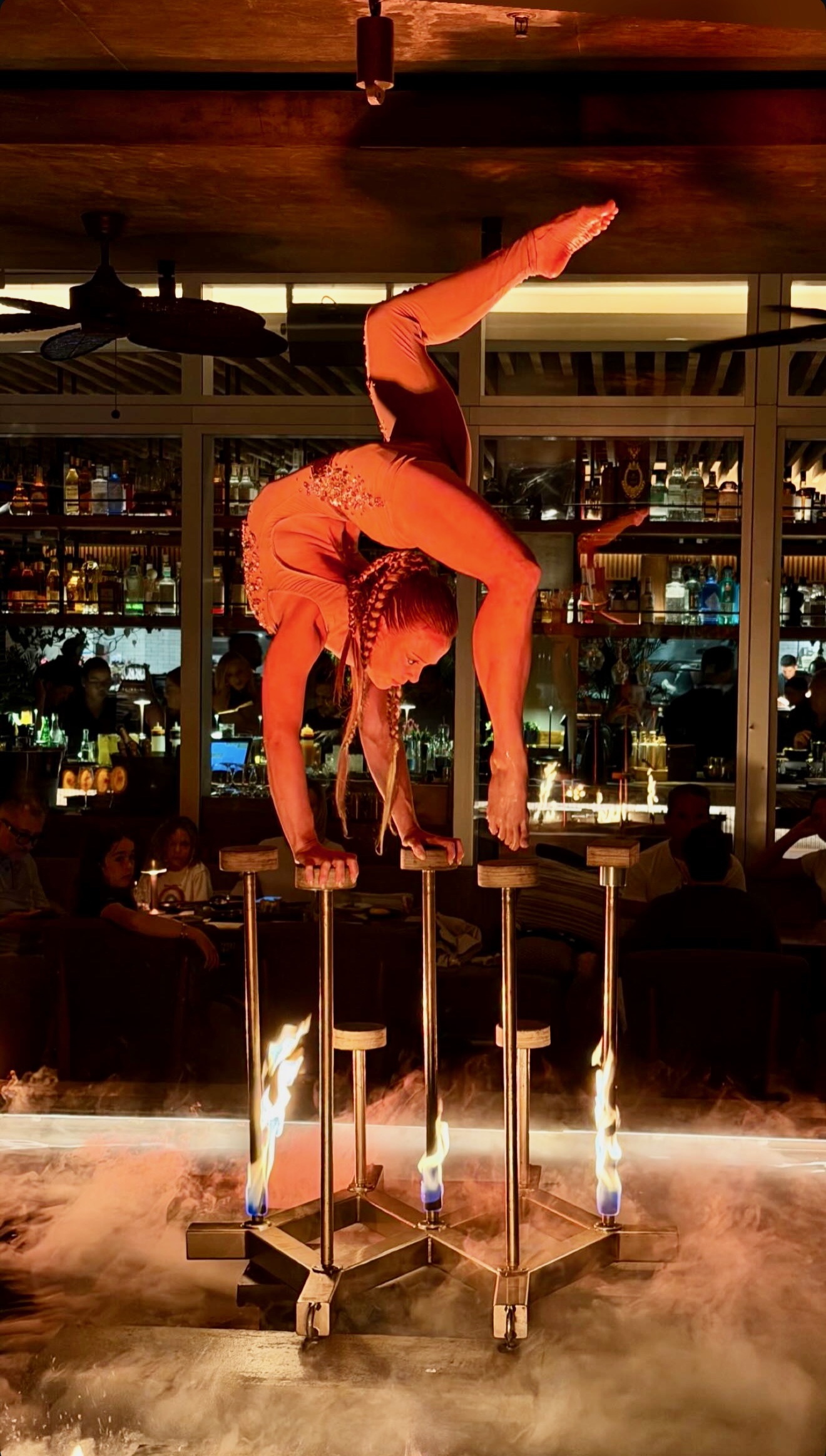 Circensia contortionist performing amid fire at a residency
