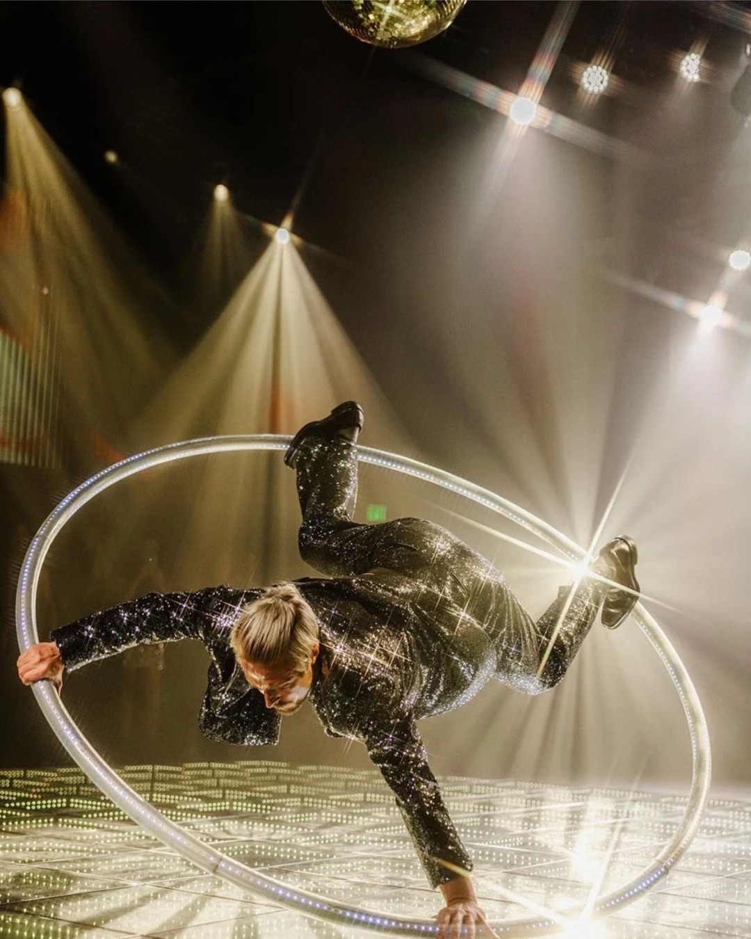 Circensia Cyr wheel artist performing beneath spotlights