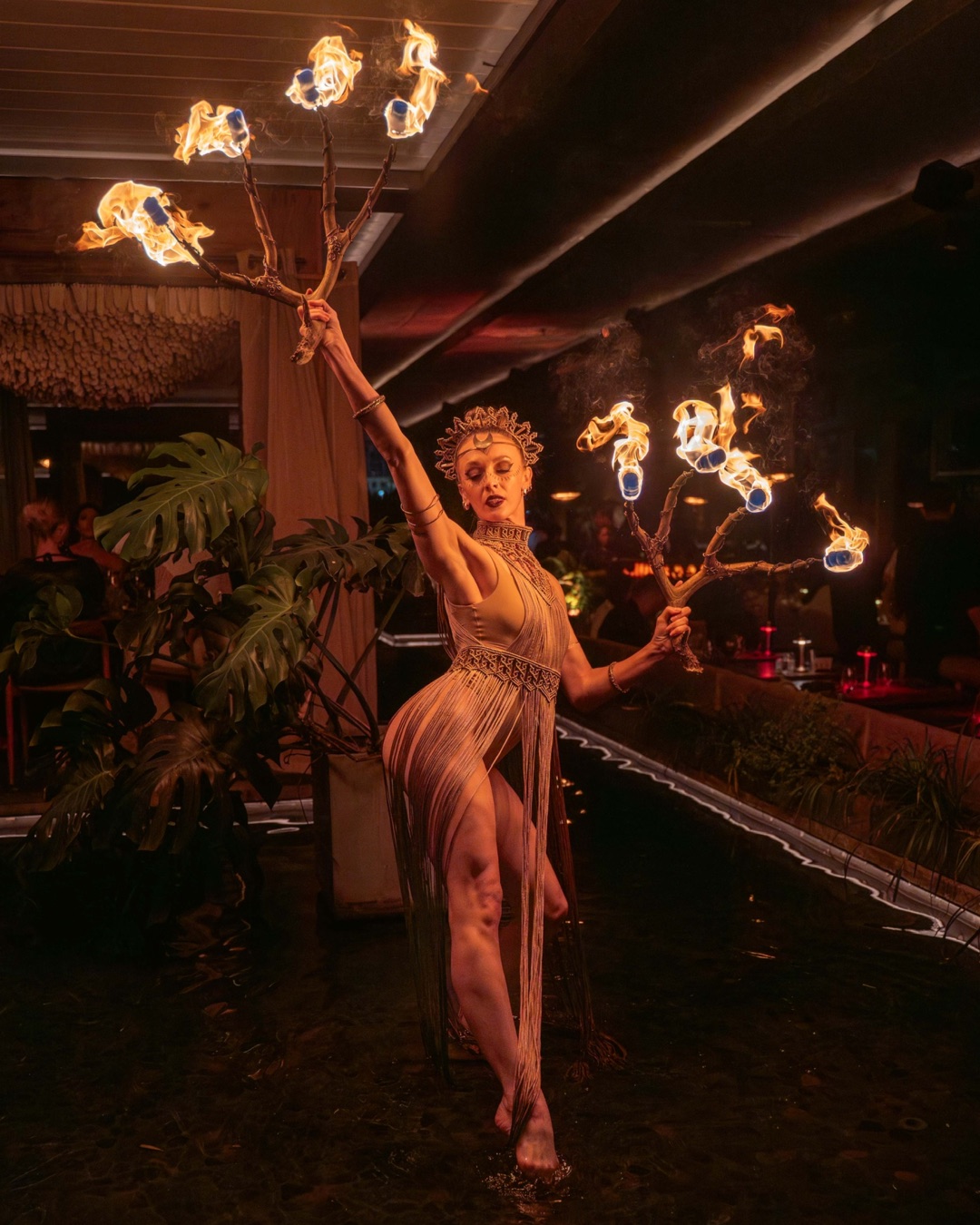 Circensia fire performer holding a multi-flame apparatus